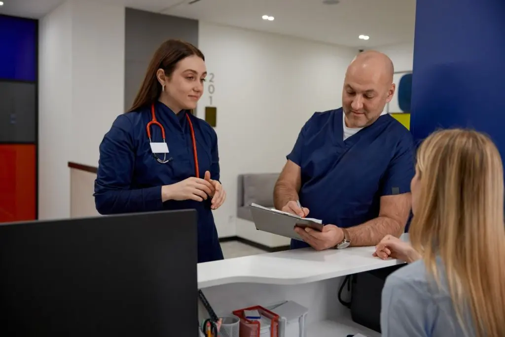 male-and-female-doctors-checking-schedule-near-rec-2026-01-06-09-15-39-utc