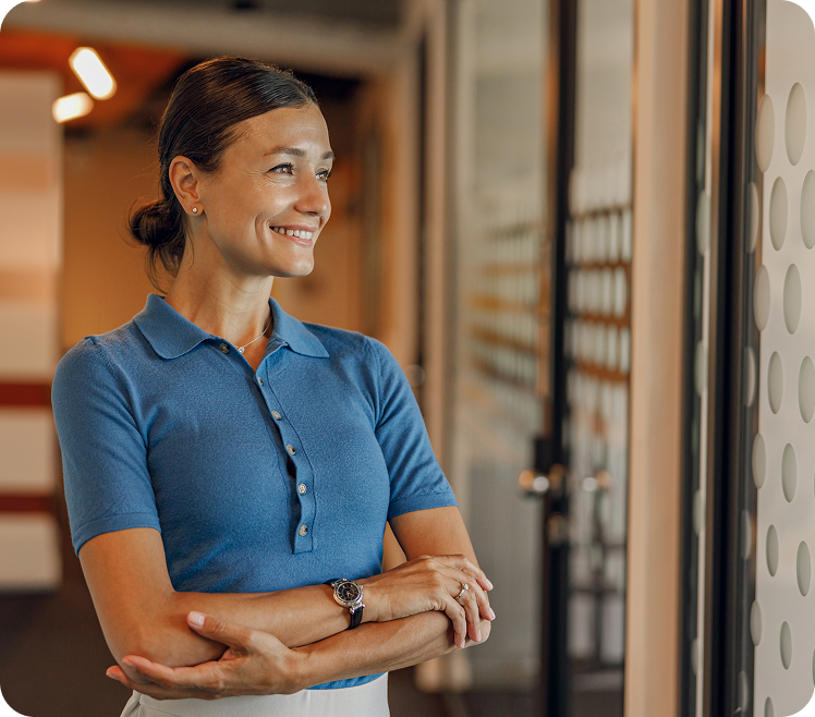 woman smiling and standing with arms crossed