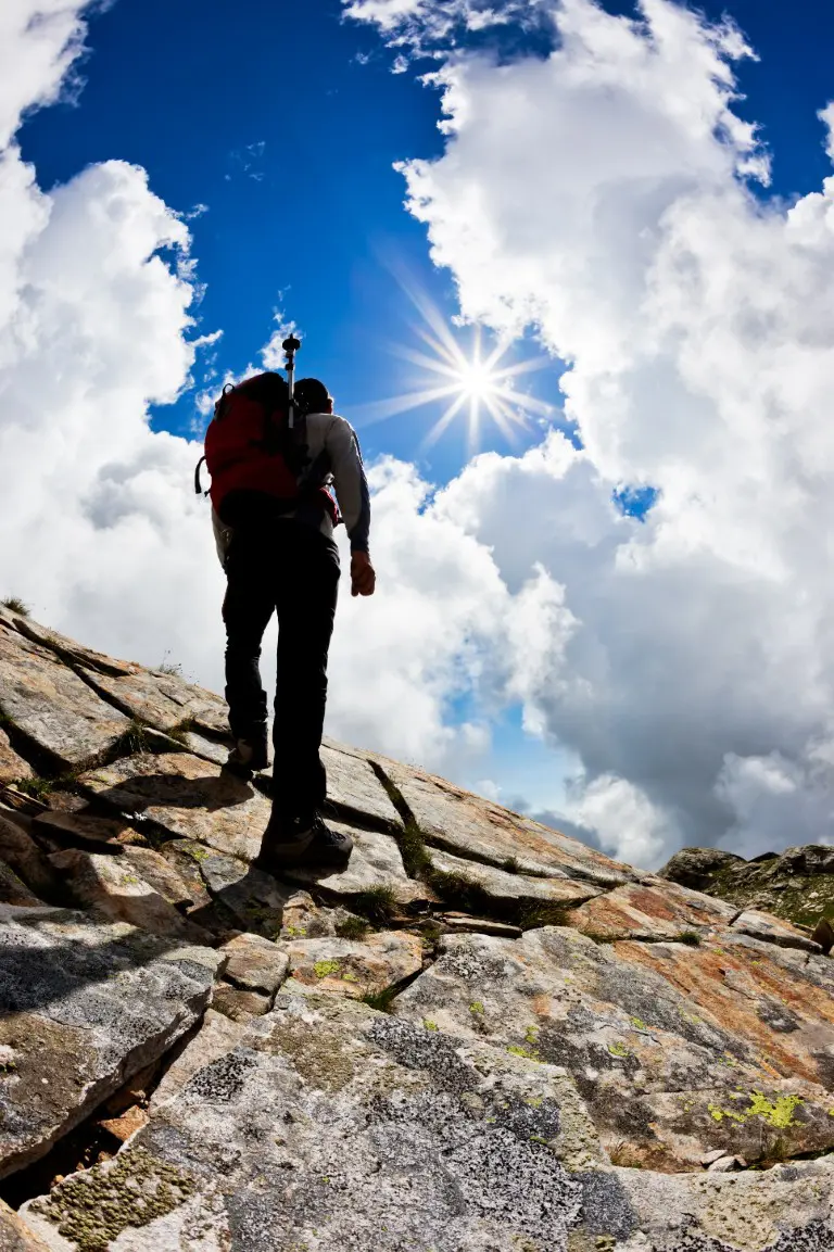 rear-view-of-a-man-hiking-up-a-rock-hill-against-a-2026-03-16-00-39-39-utc